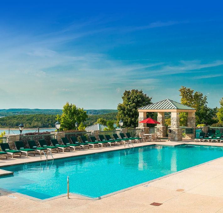 a pool with chairs and a gazebo