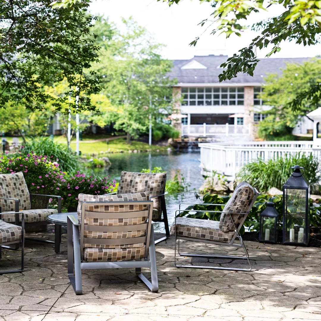 a patio area with chairs and a table