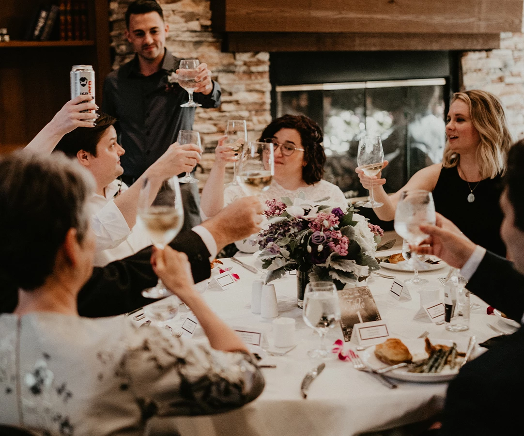 a group of people sitting around a table with wine glasses