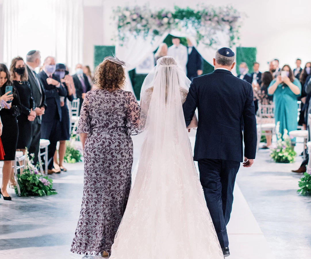 a bride and groom walking down a aisle