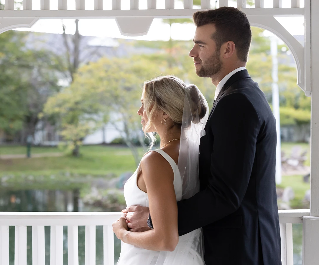 a man and woman standing on a porch