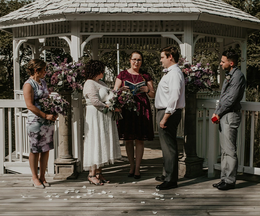 a group of people standing under a gazebo