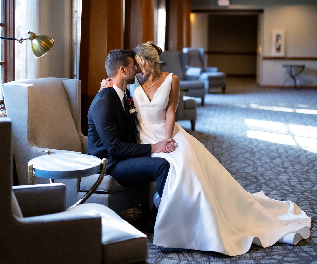 a man and woman sitting on a chair