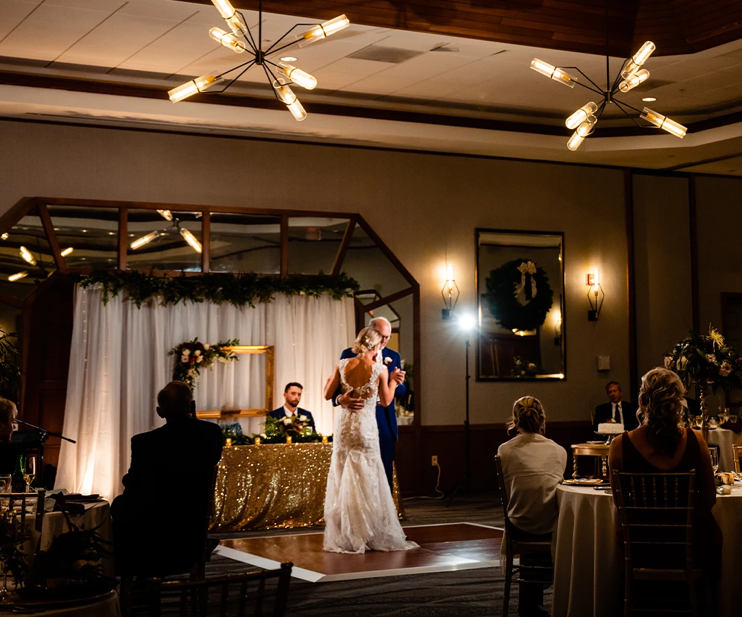 a bride and groom dancing on a stage