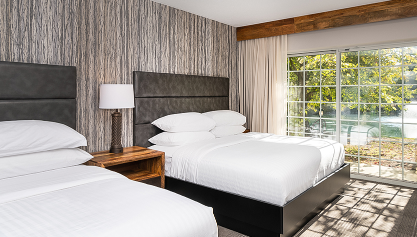 a room with two beds and a window