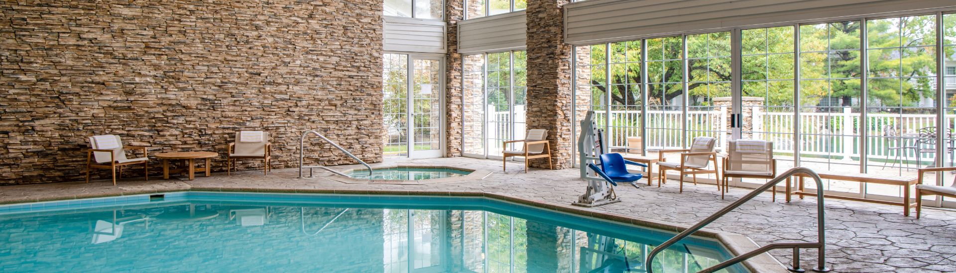 Indoor heated swimming pool with lounge seating at Cherry Valley Hotel