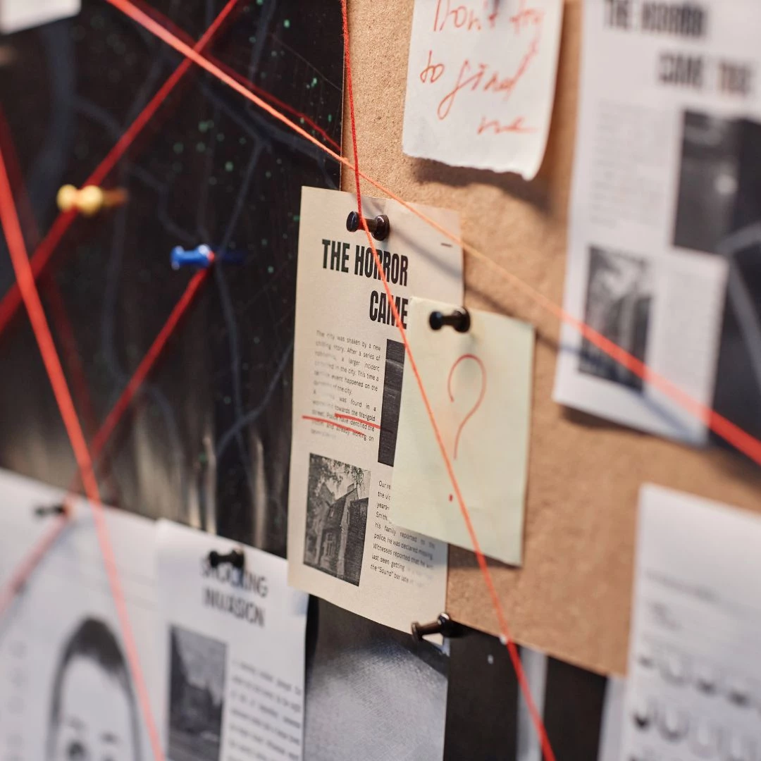 a bulletin board with papers pinned to it