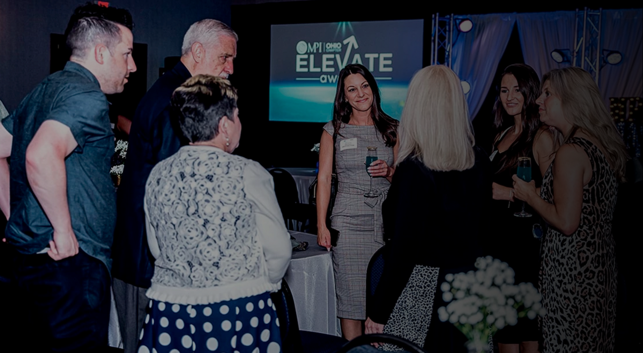 a woman standing in front of a group of people