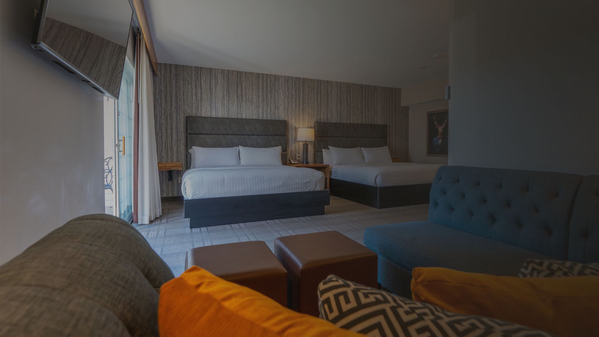 a room with two beds and a couch at cherry valley hotel