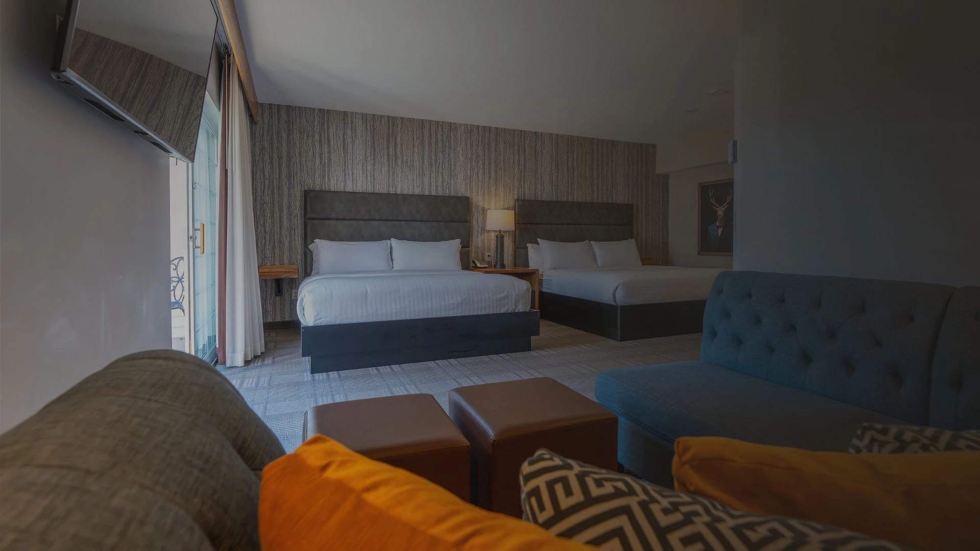 a room with two beds and a couch at cherry valley hotel