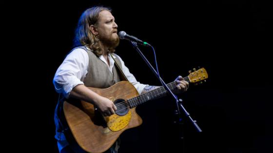 will freed playing guitar and singing into a microphone