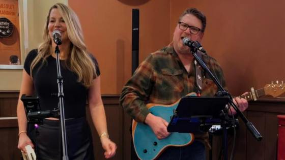 RUST AND ROASES singing into microphones