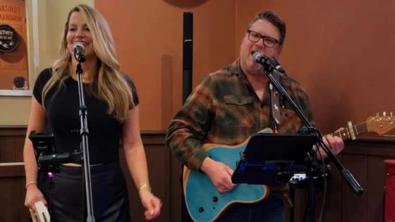 RUST AND ROASES singing into microphones