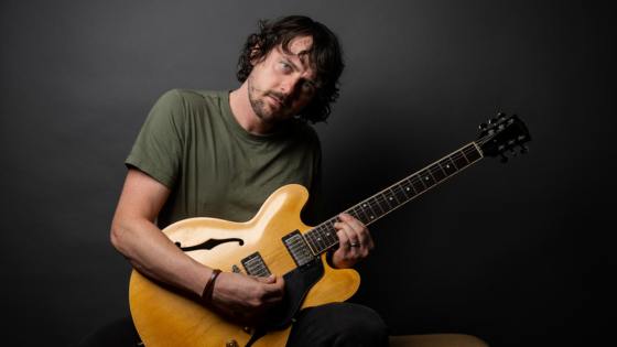 George Barrie Solo holding a guitar