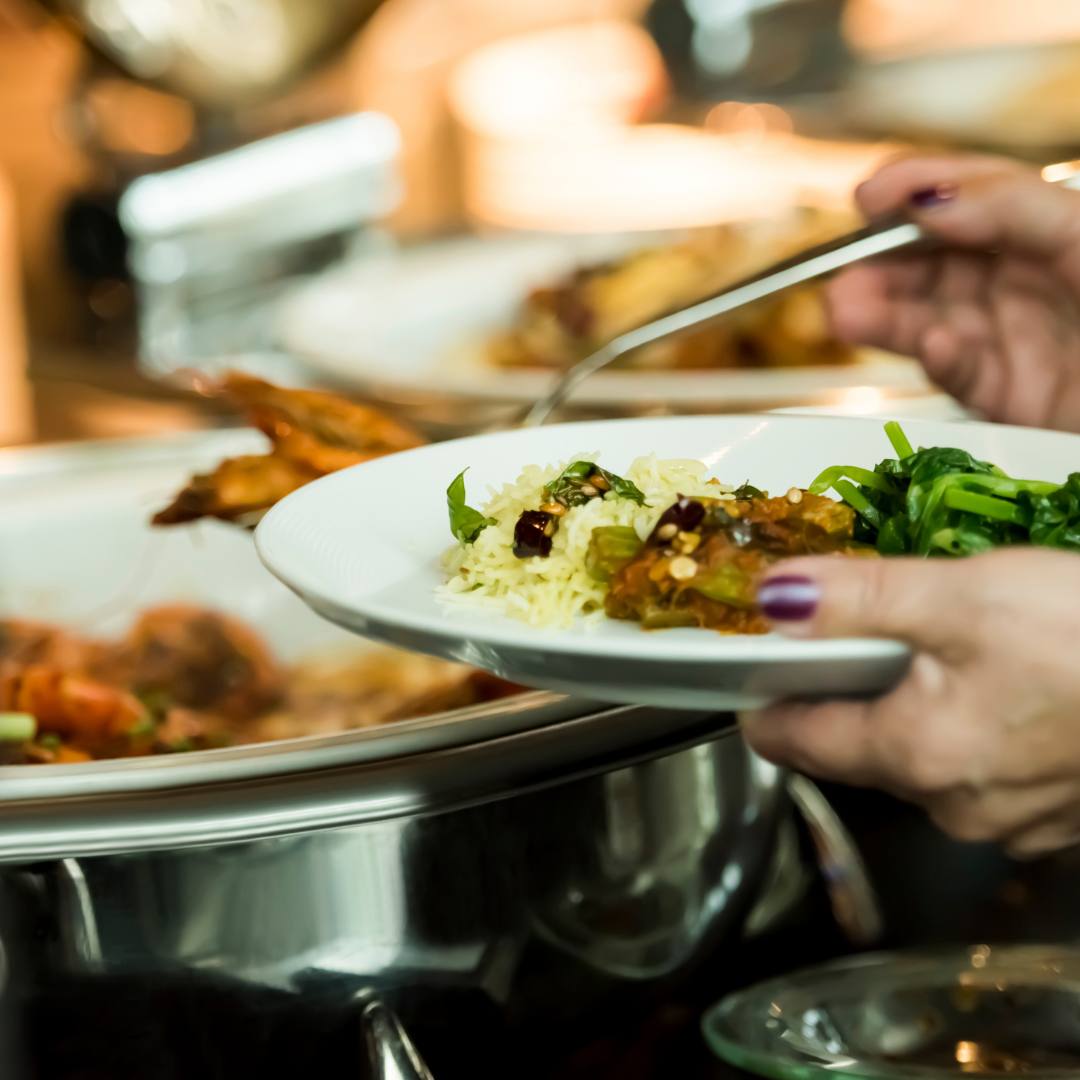 a person holding a plate of food