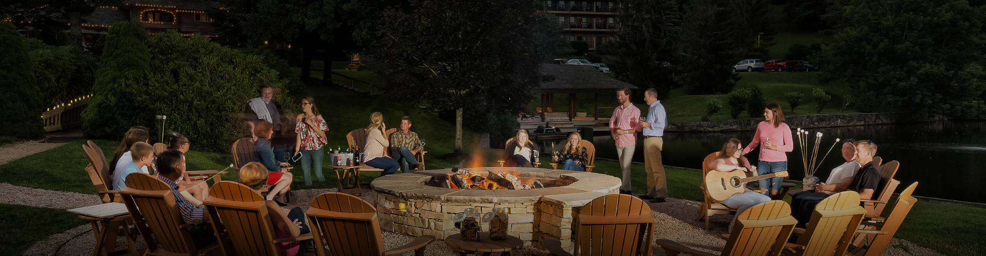 a group of people sitting around a fire pit