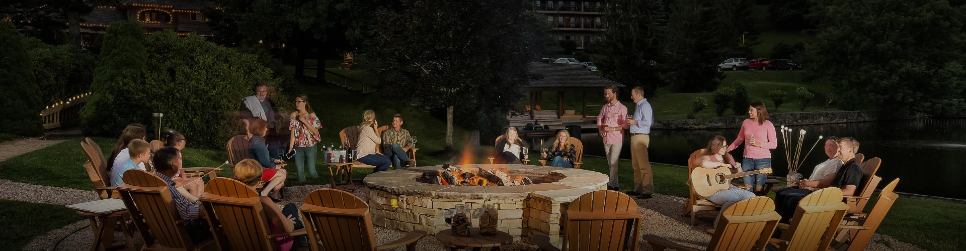 a group of people sitting around a fire pit