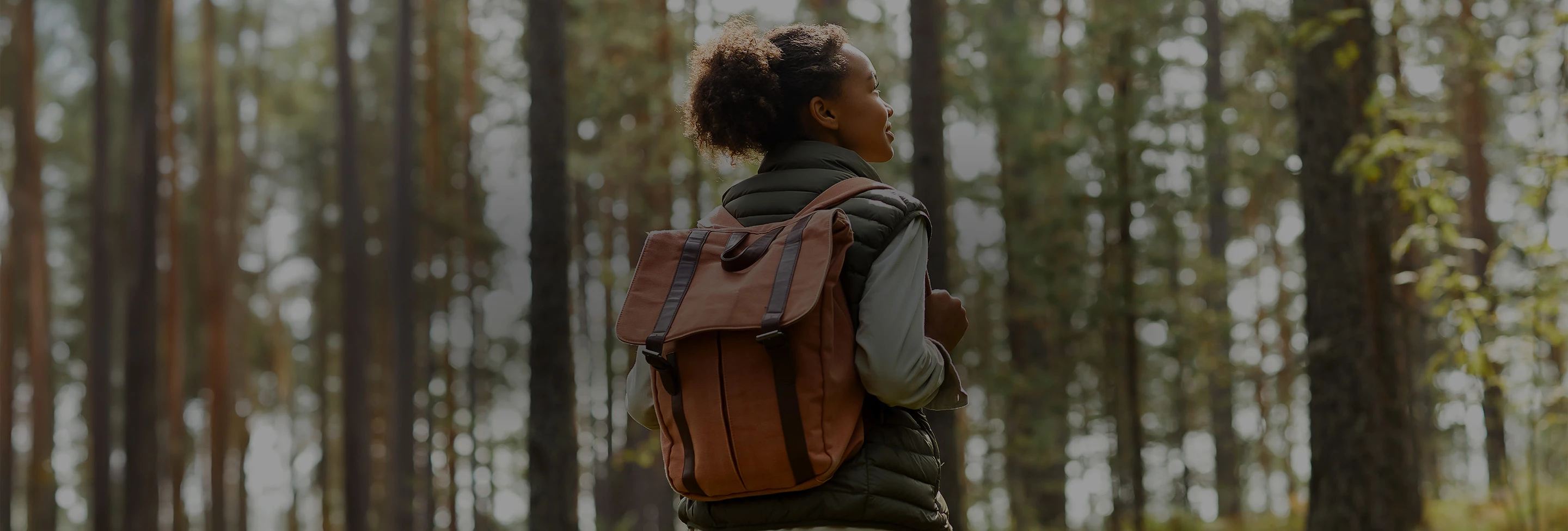a woman with a backpack in the woods