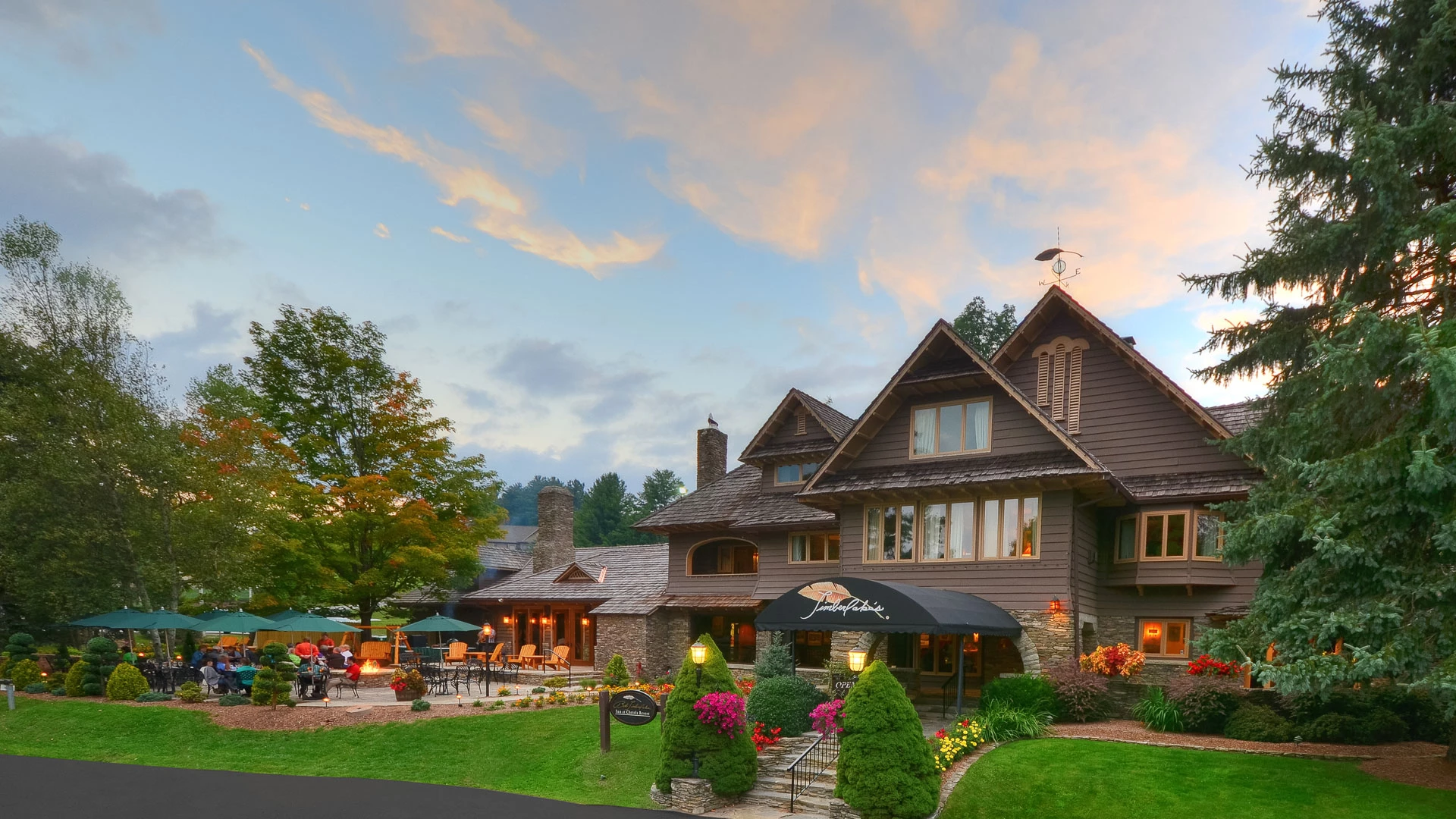 a large house with a lawn and trees