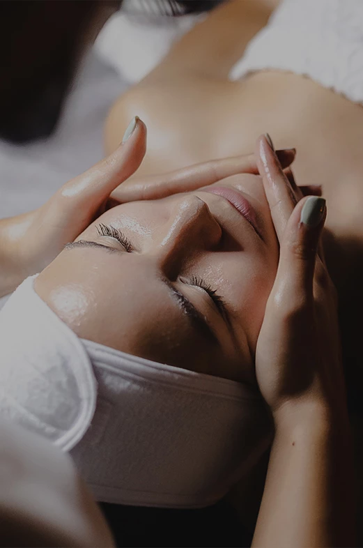 a woman receiving a face massage