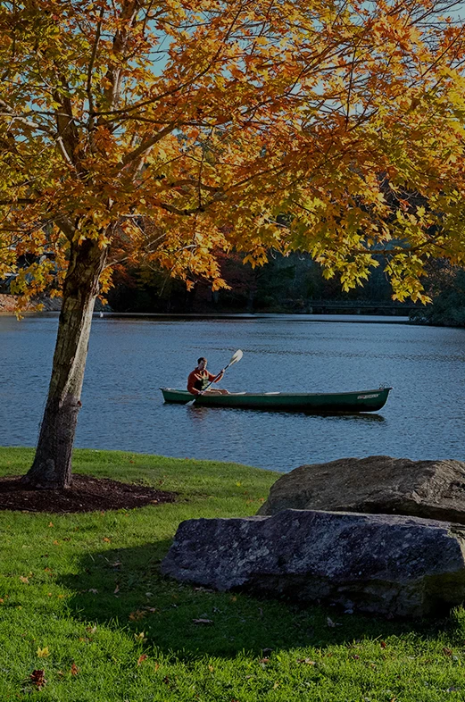 a man in a canoe on a lake