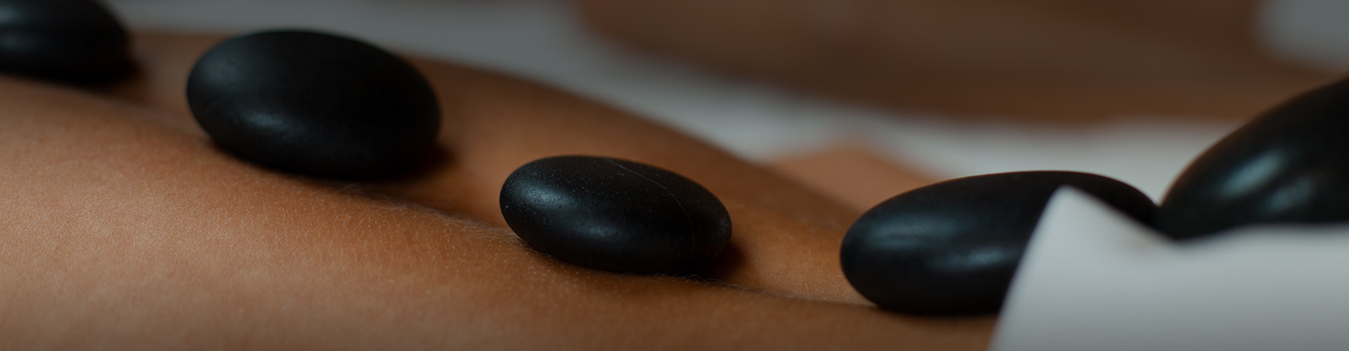 a close up of black stones on a person's skin