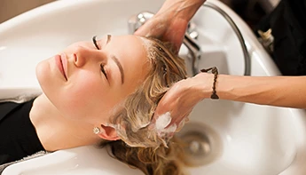 a woman washing her hair