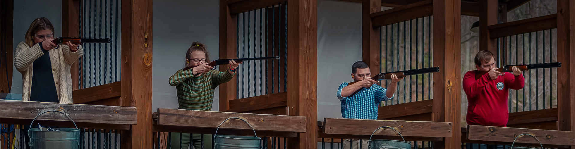 a man aiming a gun at another man
