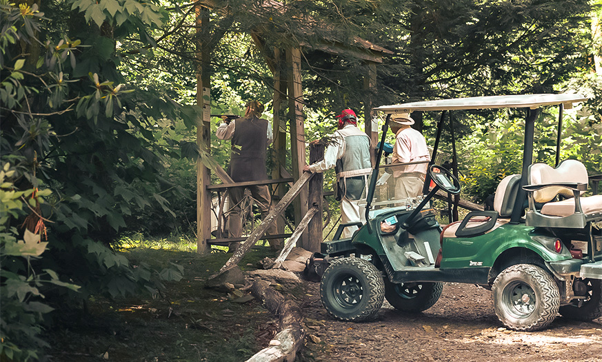a group of people standing next to a golf cart
