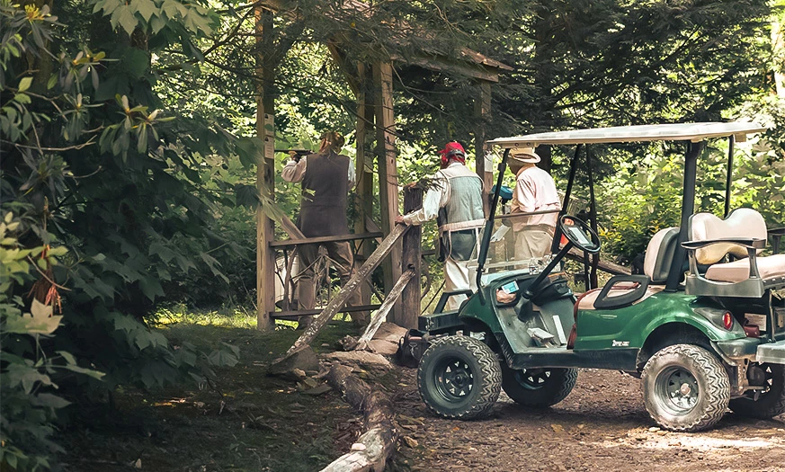 a group of people standing next to a golf cart