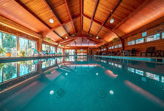 a indoor pool with a wooden ceiling
