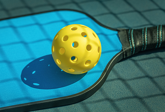 a yellow ball on a paddle