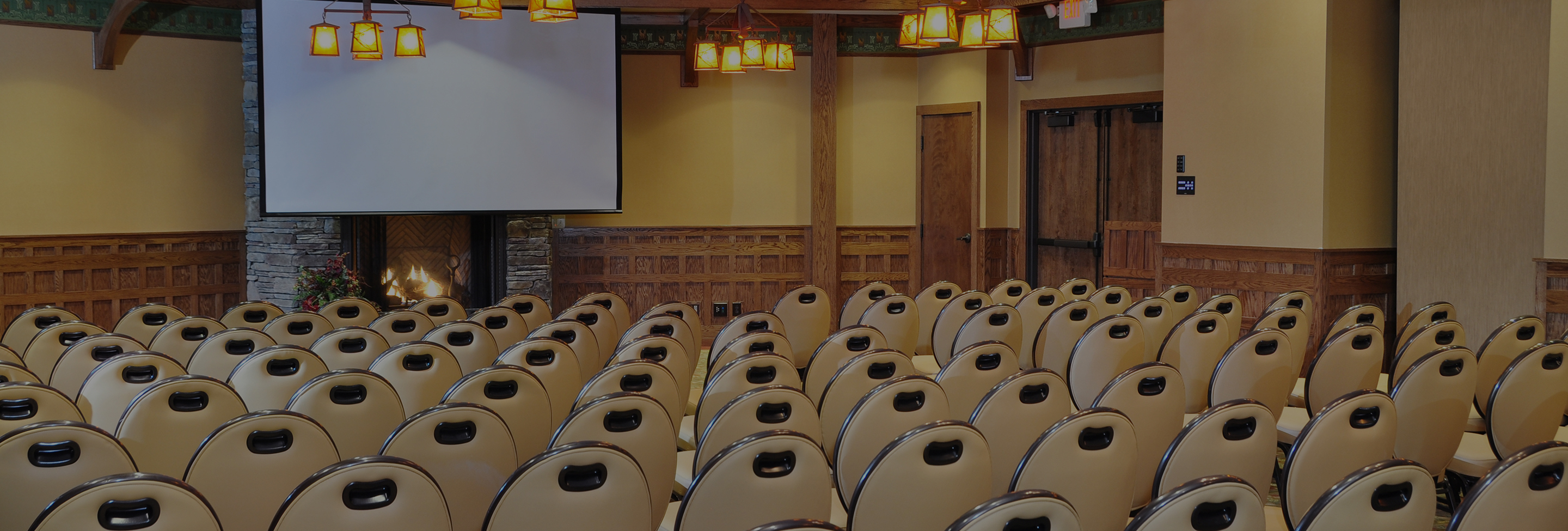 a room with chairs and a projector screen