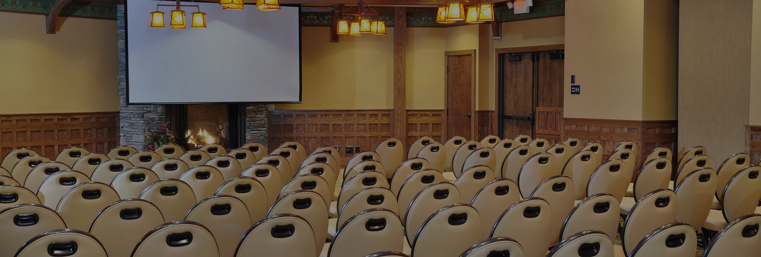 a room with chairs and a projector screen