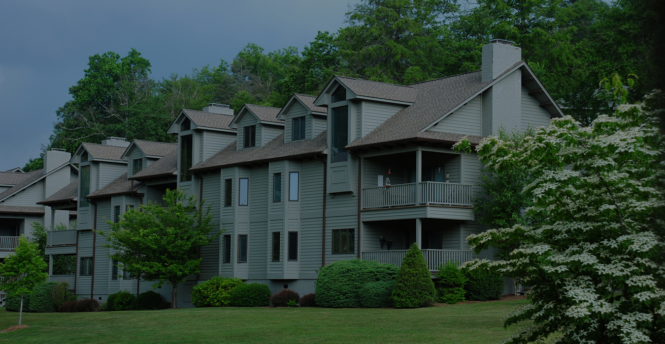 a large building with trees and bushes