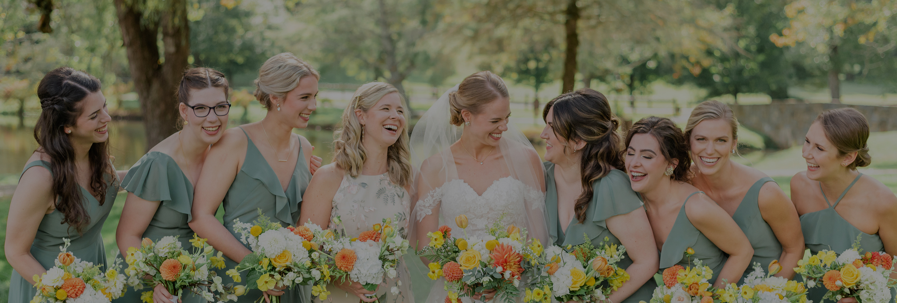 a group of women in dresses with flowers