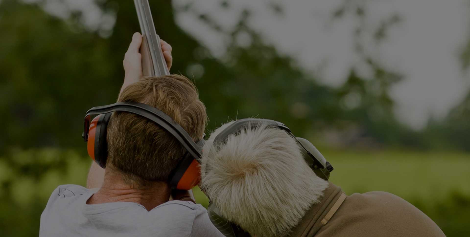 a man with headphones on and another man with a gun