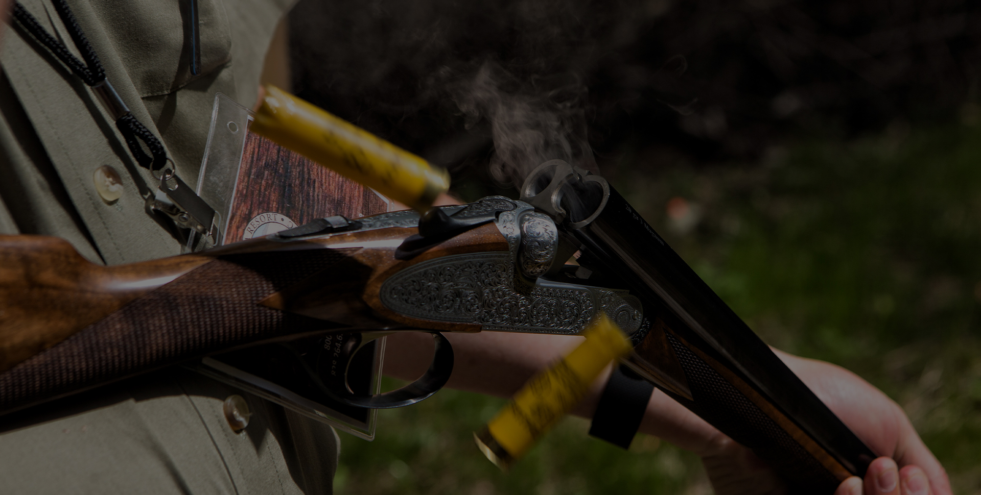 a person holding a gun with cartridges
