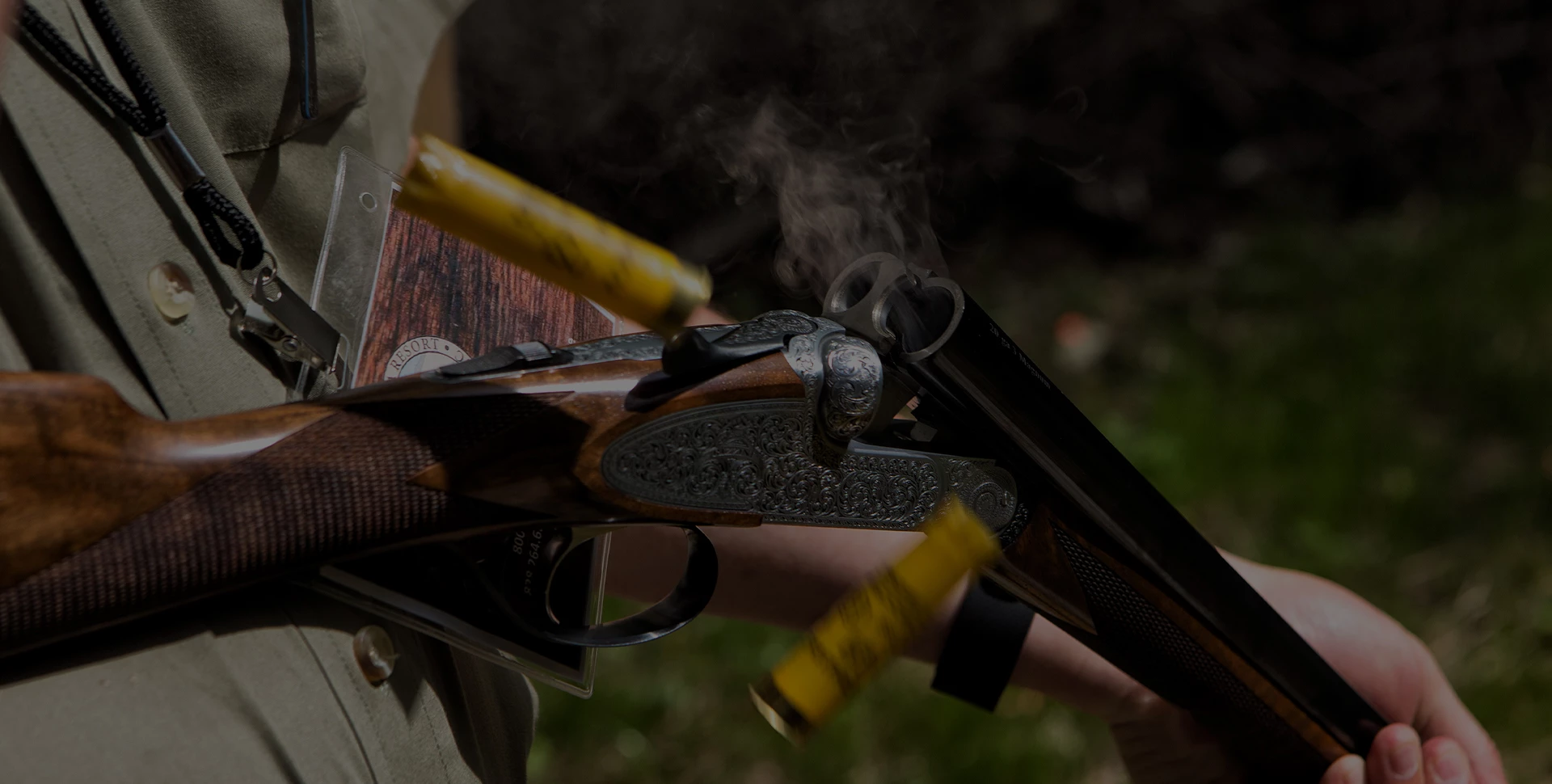 a person holding a gun with cartridges