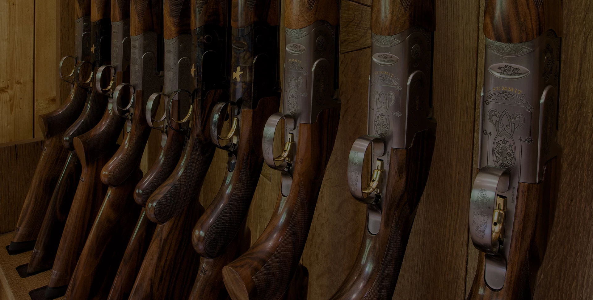 a row of guns on a shelf