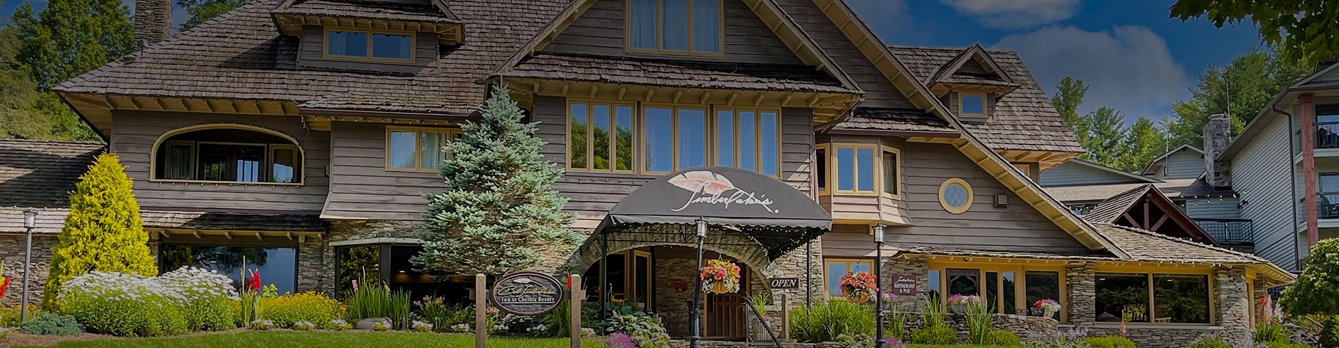 a building with a sign and a tree