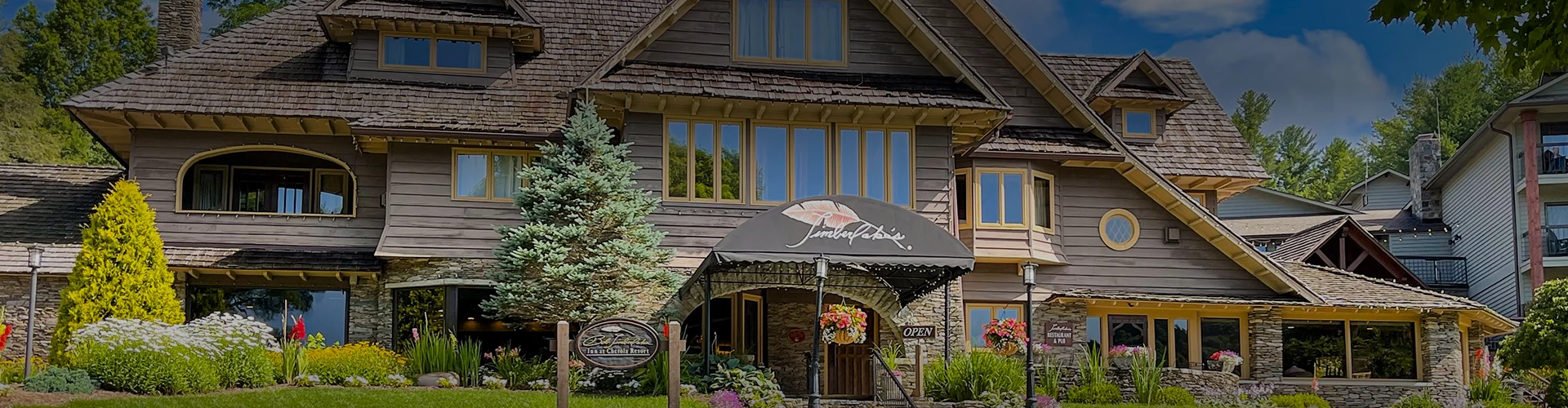 a building with a sign and a tree