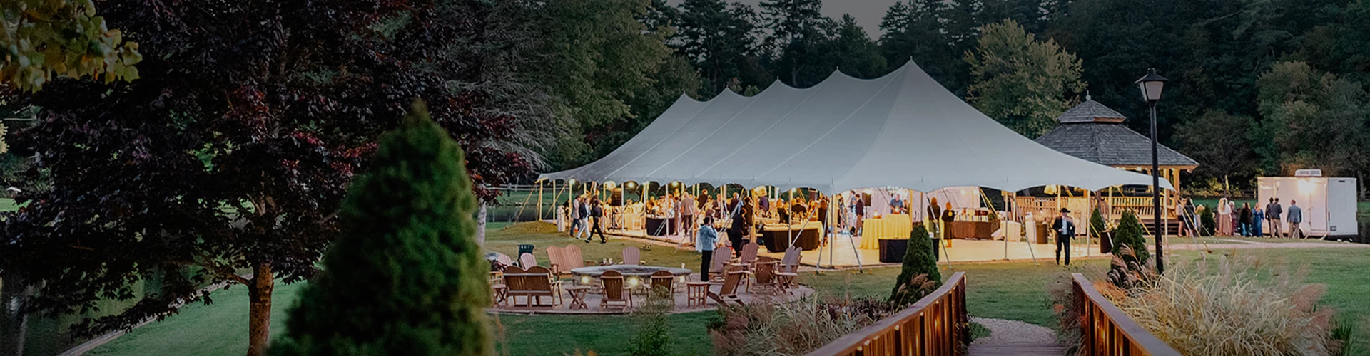 a large white tent with people around it