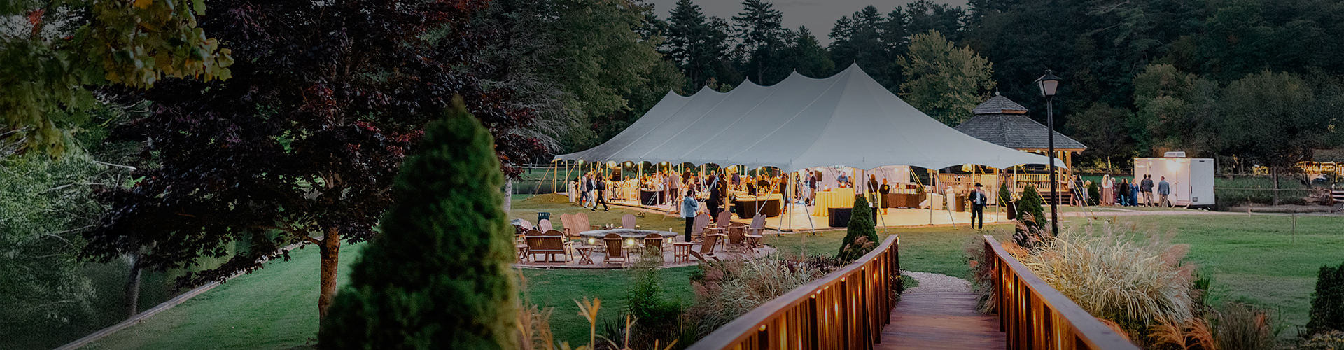a large white tent with people around it