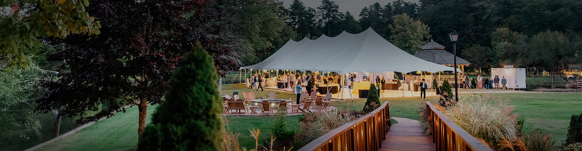 a large white tent with people around it