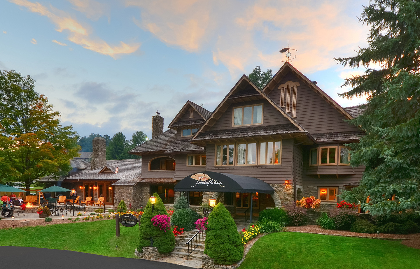 a large house with a lawn and a black awning