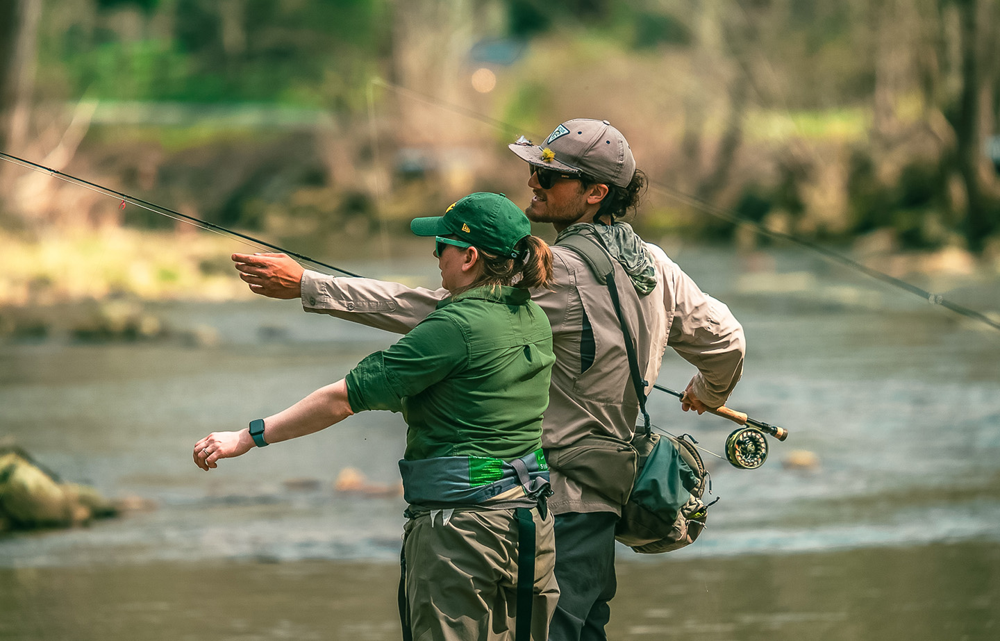 a man and woman fishing in a river