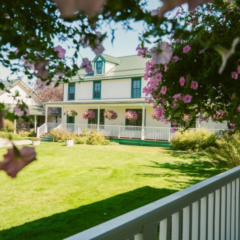 an inn with a lawn and flowers