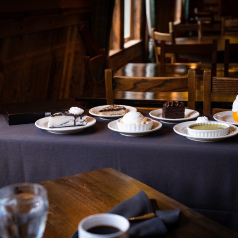 a table with plates of desserts.