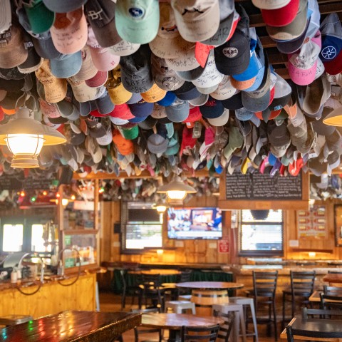 a room with many hats from the ceiling.
